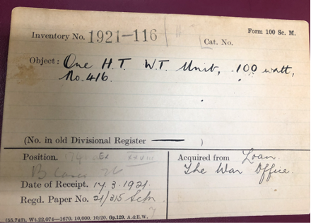 A catalogue card from the Science Museum with writing that reads; 'One H.T W.T Unit, 100 watt, no, 416.' In black cursive handwriting. 